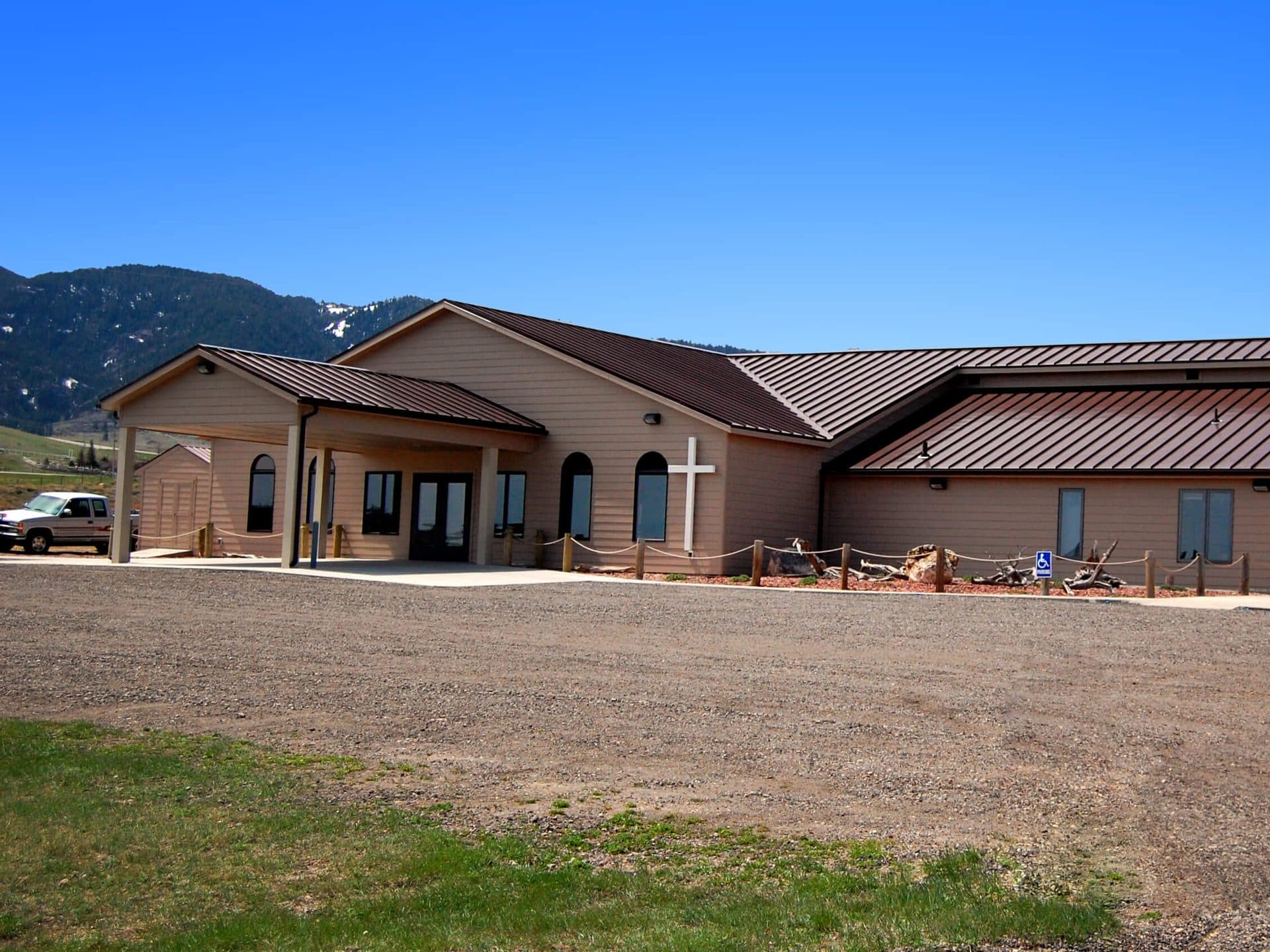 The carport entrance and gravel parking lot at Lord of Lords Lutheran Church.