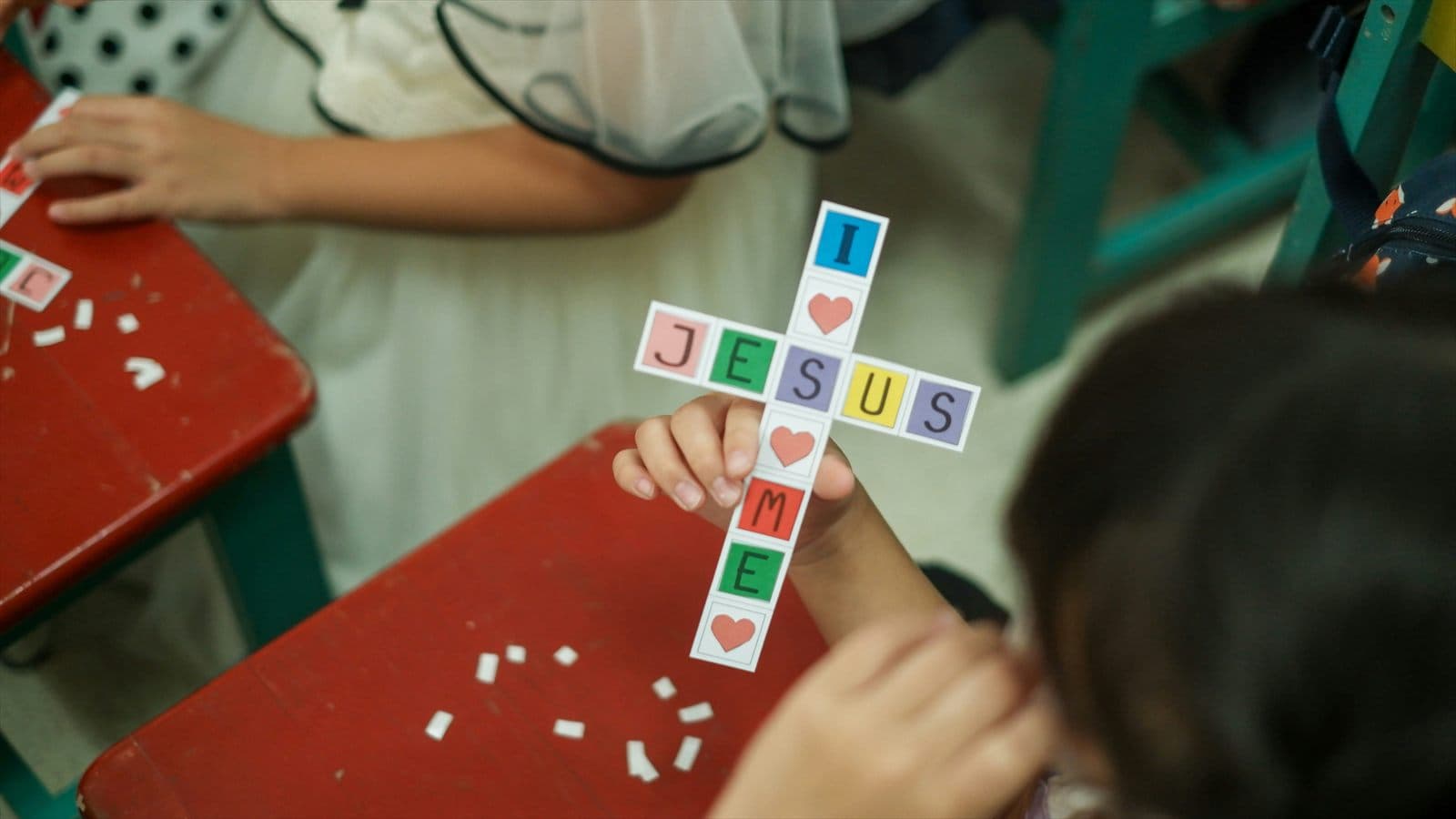 Children making a cross during Sunday school